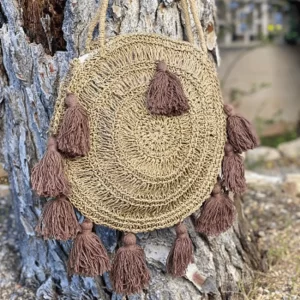 Round handbag made in Bali with brown tassels